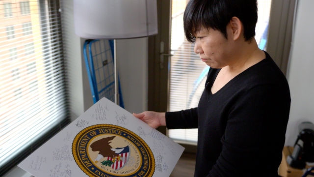 Former immigration judge Traci Hong looks at memorabilia from her time on the bench.