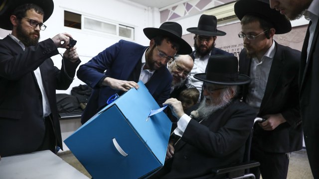 Israeli man votes in the country's third general election in under a year