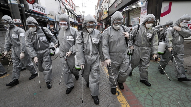 Army soldiers wearing protective suits spray disinfectant as a precaution against coronavirus in Seoul, South Korea
