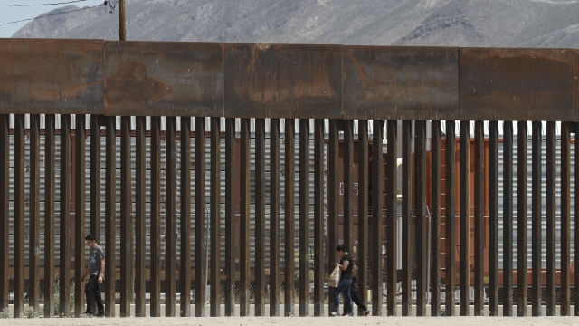 Migrants Walk Along The Border In El Paso