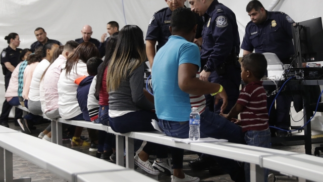 Migrants waiting at an immigration hearing facility