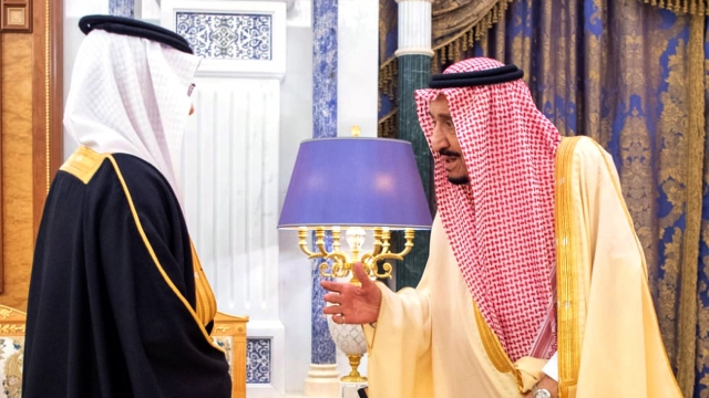 Saudi King Salman welcoming an ambassador