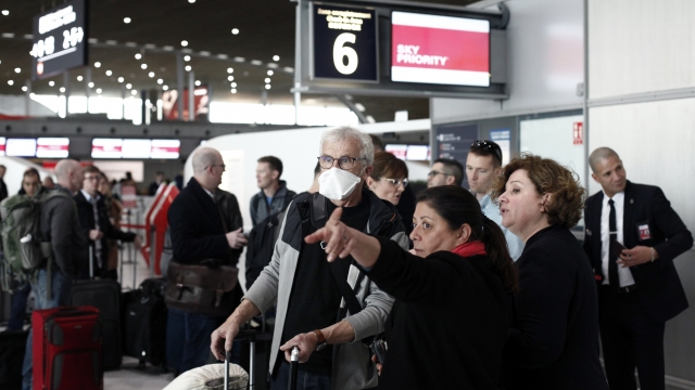 Passenger gets directions March 12, 2020, at Roissy Charles de Gaulle Airport near Paris.