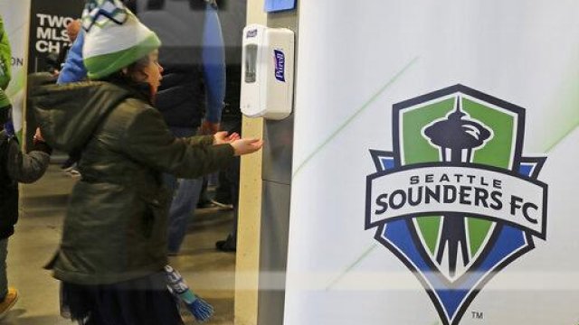 A young fan makes use of a hand-sanitizing station at CenturyLink Field