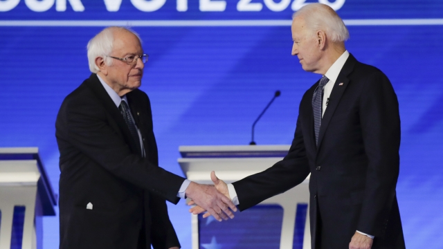 Bernie Sanders and Joe Biden shake hands on the debate stage