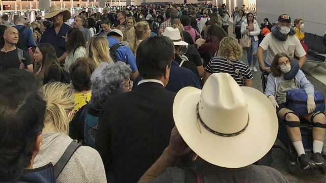 People wait in line to go through customs at Dallas Fort Worth International Airport in Grapevine, Texas
