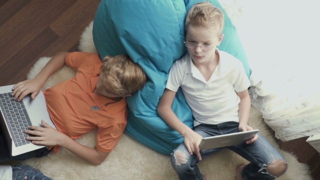 Kids use laptops and tablets