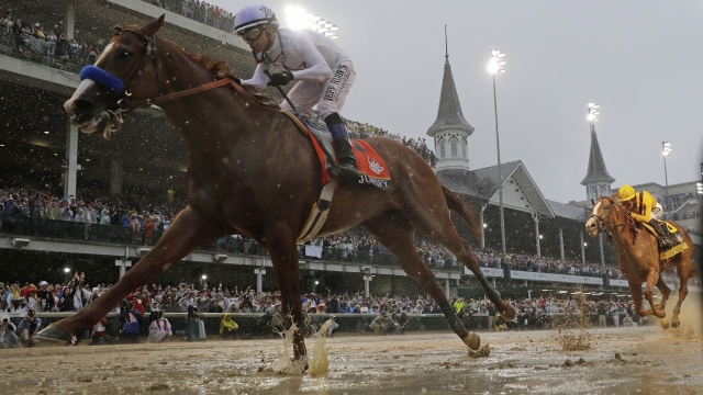 Jockey Mike Smith and the horse Justify ride to victory in the 2018 Kentucky Derby.
