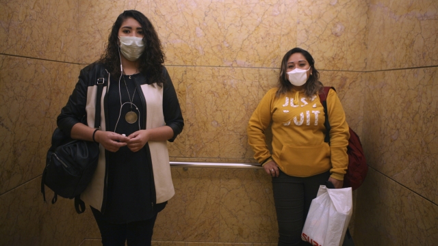 Two women in Mexico wear masks to protect against coronavirus