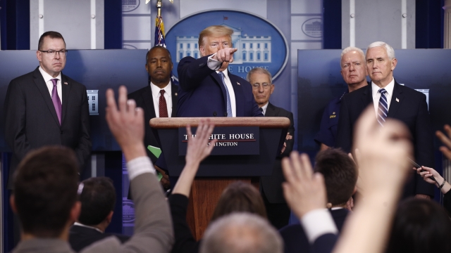 Donald Trump with staff at Saturday briefing