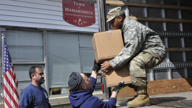 A member of the New York National Guard carries supplies