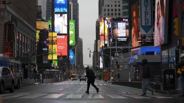 Man walking through almost empty Times Square
