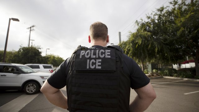 In this July 8, 2019, file photo, an ICE officer looks on during an operation in Escondido, Calif.