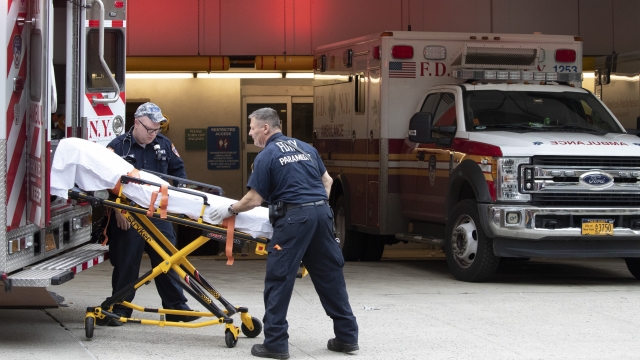 FDNY paramedics place an empty stretcher into an ambulance