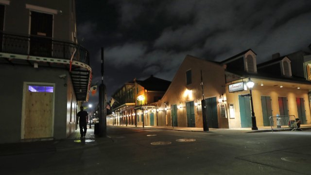 A man strolls nearly deserted French Quarter in New Orleans.