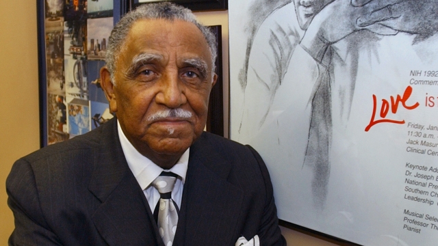 The Rev. Joseph Lowery poses with a line drawing of Martin Luther King, Jr. in his office