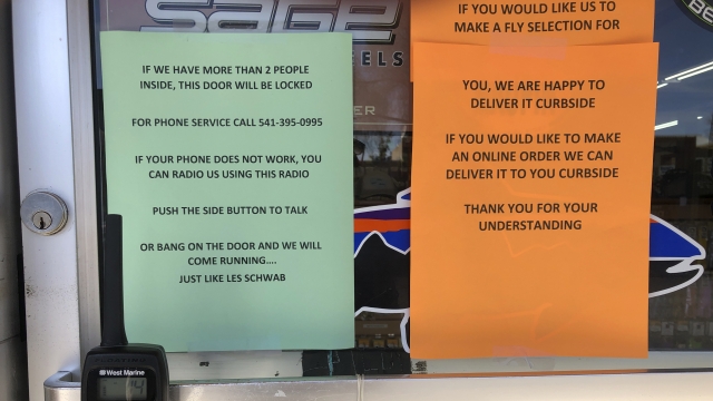 A sign outside a fly fishing shop in tiny Maupin, Oregon, advises customers of new policies