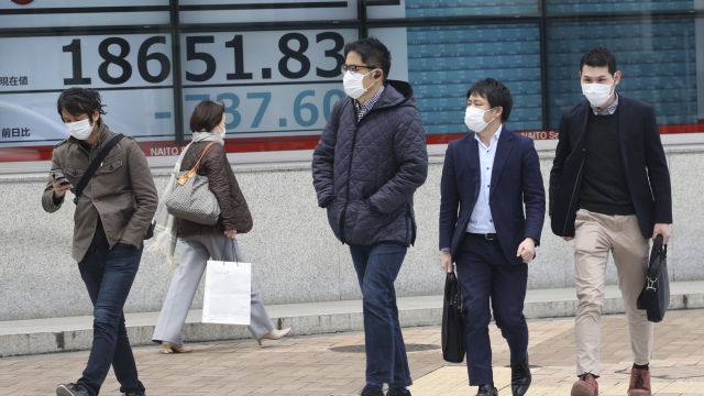 People walk by with medical masks on in Tokyo, Japan.