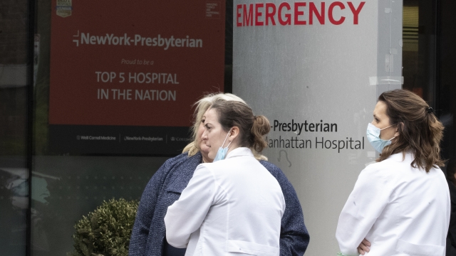 Medical personnel talk outside the emergency room at NewYork-Presbyterian Lower Manhattan Hospital, Wednesday, March 18, 2020