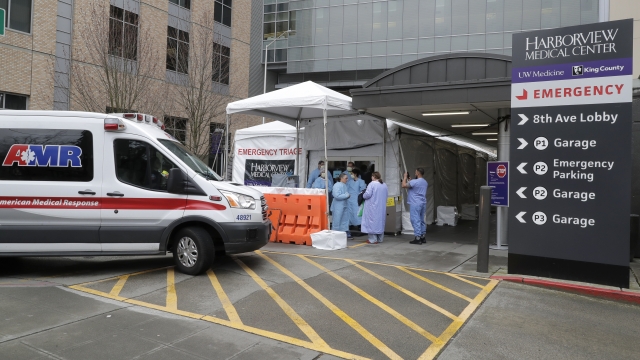 An ambulance pulls up outside a triage tent for the Emergency Department at the Harborview Medical Center hospital