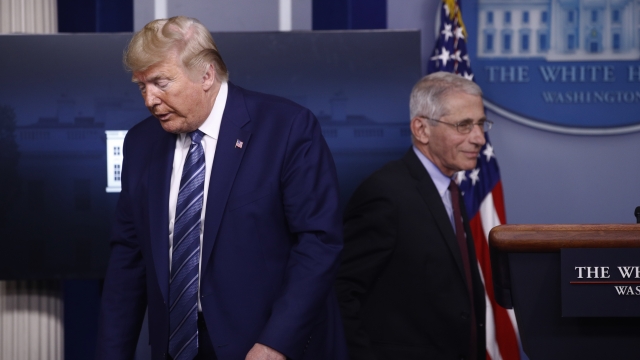 Dr. Anthony Fauci walks past President Donald Trump to answer a question during an April 5 coronavirus task force meeting