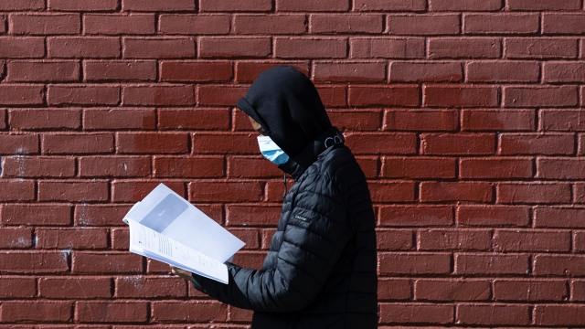 Person in mask with workbook