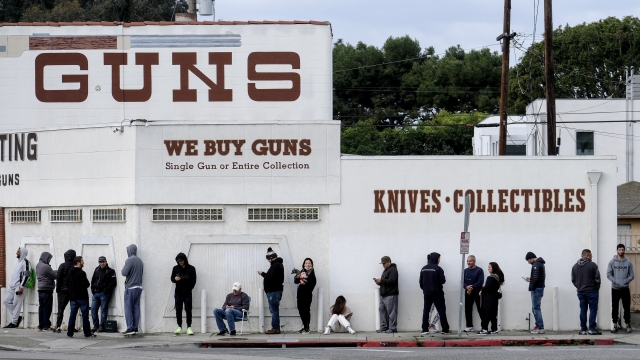 Customers wait outside a California gun store