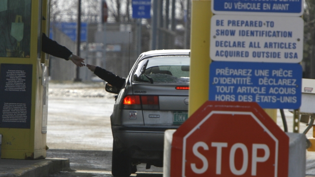 A traveler presents documents at the Canada-U.S. border crossing in Highgate Springs, Vt.