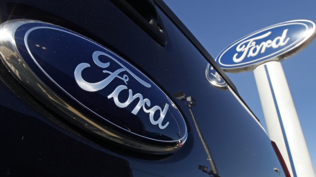 a Ford logo, on the tailgate of a pick-up truck, and on a Ford dealership sign