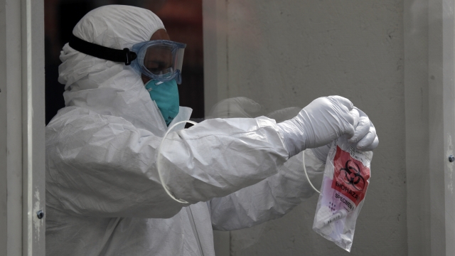 Person with coronavirus test kit sample bag