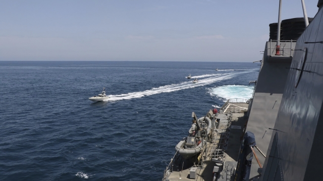 Iranian Revolutionary Guard vessels sail close to U.S. military ships