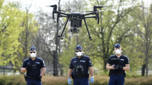 Police officers test a drone