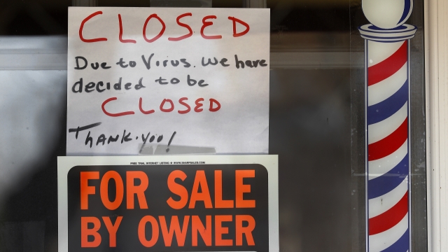 "Closed" and "for sale" signs in a business window