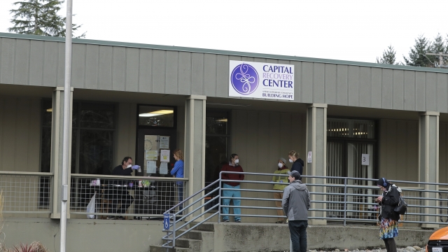 Patients line up to pick up medication for opioid addiction at a clinic in Olympia, Wash.