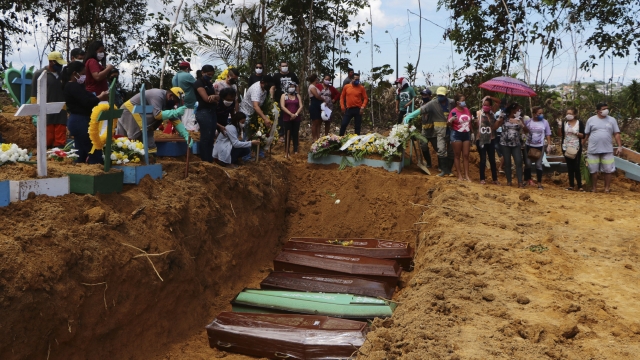 Mourners at the site of a mass burial in Brazil
