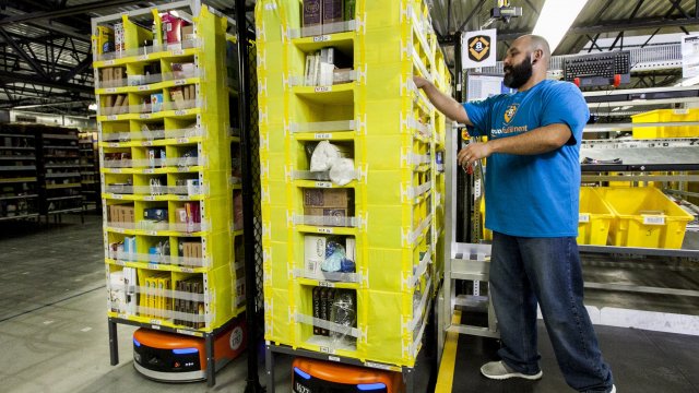 An Amazon employee checks orders at a warehouse