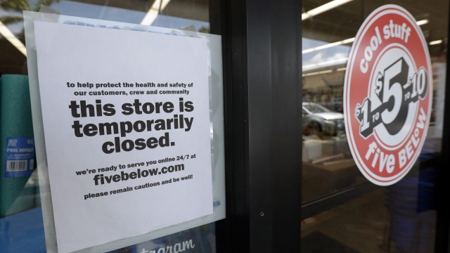 A sign is posted on a closed store in North Miami, Fla.