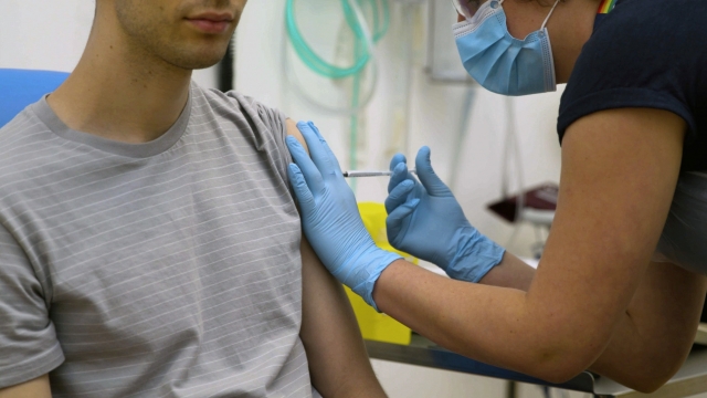 A volunteer is injected with an experimental COVID-19 vaccine