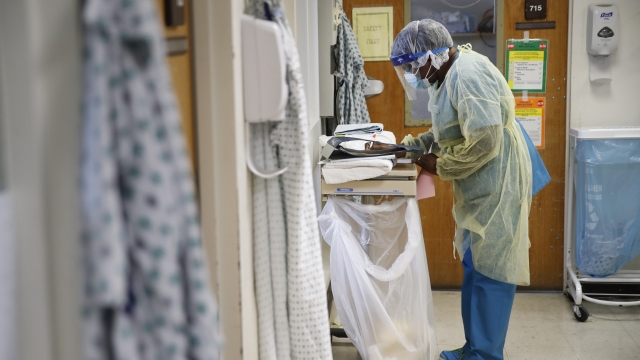An intensive care unit staff member wears personal protective equipment