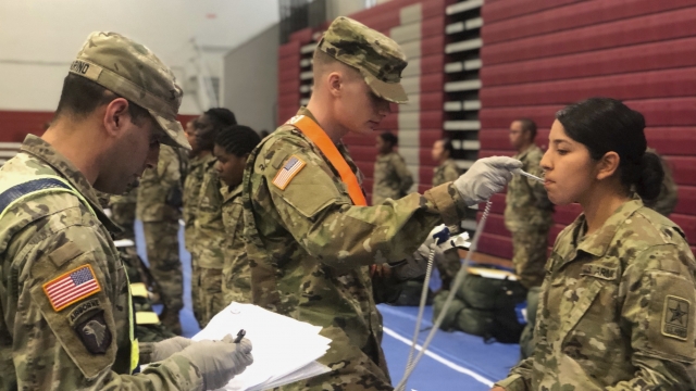 Recent Army basic combat training graduates have their temperatures