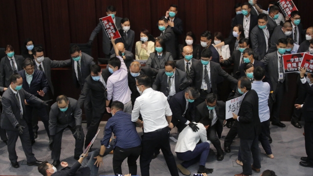 Scuffles break out Friday between pro-democracy and pro-China lawmakers in Hong Kong.