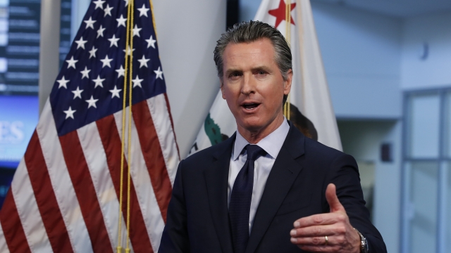 California Gov. Gavin Newsom gestures during a news conference.