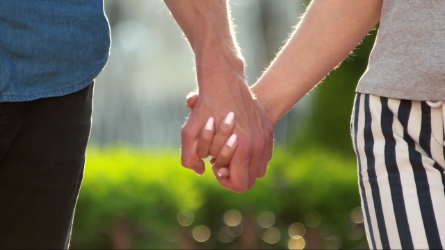 A couple holds hands