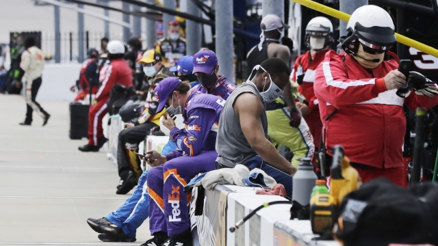 Crew members and officials wait in the pit area before the start of the NASCAR Cup Series auto race Sunday, May 17, 2020, in