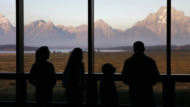 Silhouette of people admiring the Grand Tetons at Yellowstone National Park.