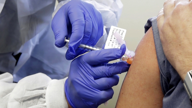 Man receives a shot in the first-stage safety study clinical trial of a potential vaccine for COVID-19