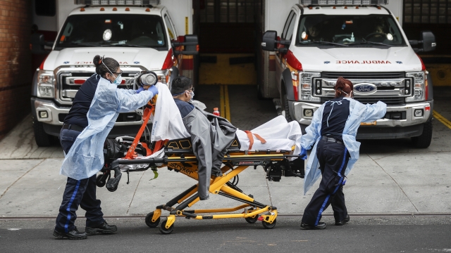 Patients are brought into Wyckoff Heights Medical Center in Brooklyn, New York City by staff wearing personal protective gear