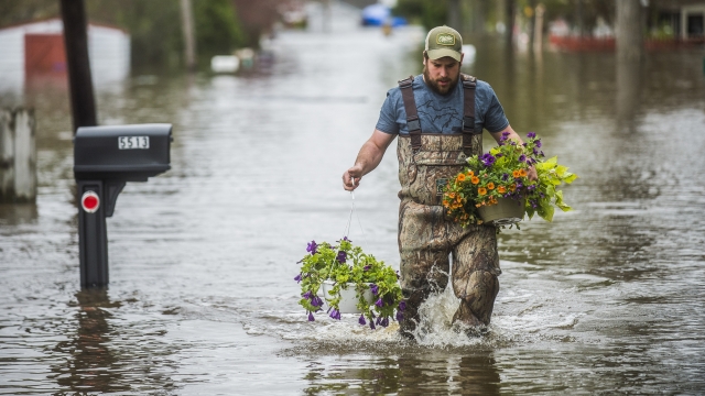 Man wading through flooded Michigan