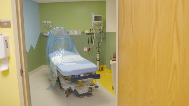 A hospital bed with a "corona curtain"