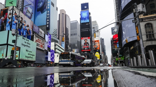 Vehicles move through a nearly empty Times Square